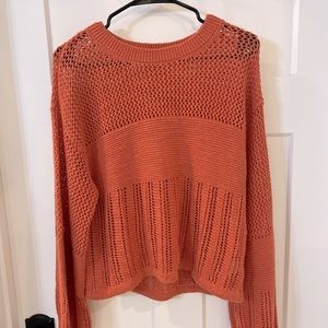 American Eagle sweater. I would say it’s a dull peachy/orange color. Size small